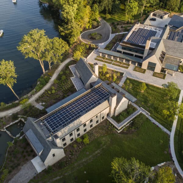 The two new buildings on the grounds, the visitor center and an administrative building. Beside the buildings you can see the Ford Cove. Note the rooftop solar panels. Image courtesy of Ford House.